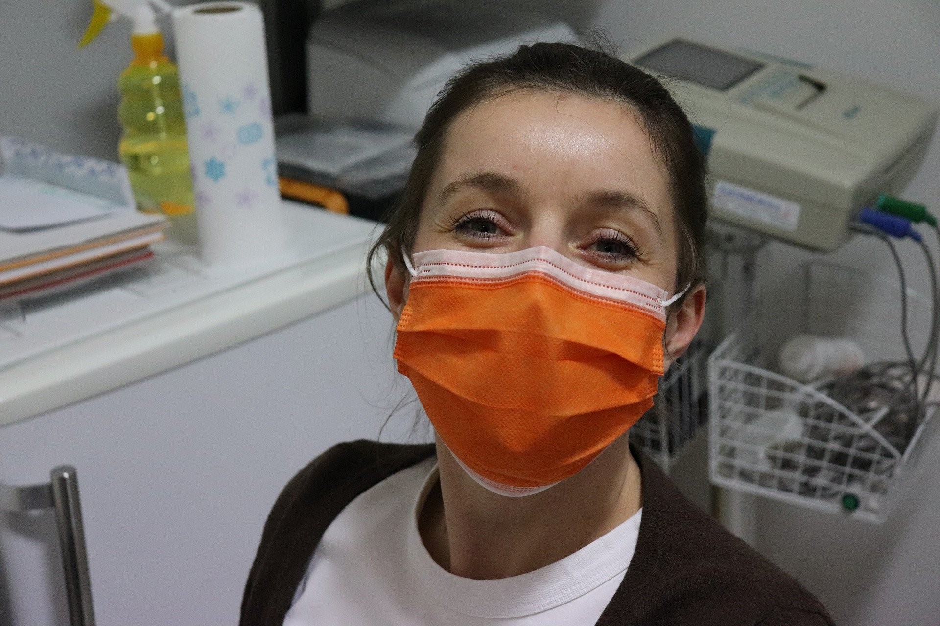 Female healthcare worker in orange mask